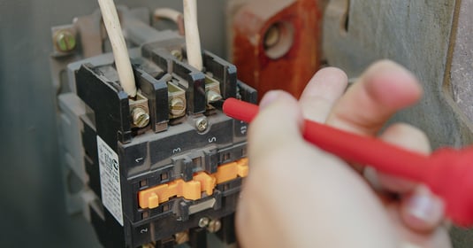 Electrician using a screwdriver