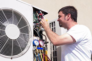 Korellis Systems Control engineer on a ladder repairing HVAC equipment