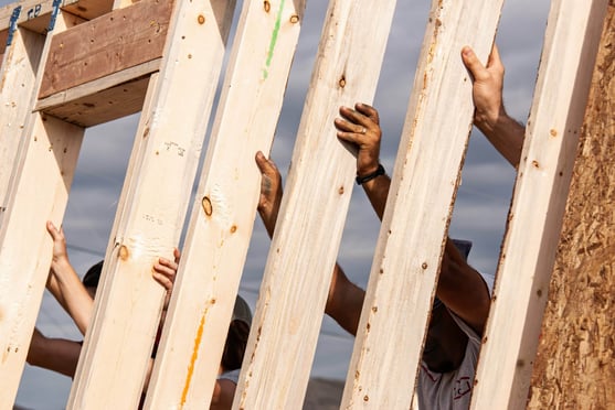 Construction workers building a wall sustainably