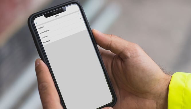Engineer using Joblogic's REFCOM F-Gas tracking module on their mobile phone